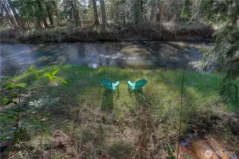 Peaceful river frontage with your own private spot to relax, unwind, and enjoy the soothing sounds of the water—perfect for quiet mornings, fishing, or simply taking in the natural beauty.    Private riverside setting with a peaceful seating area, an ideal spot to unwind, enjoy nature, and take in the calming views right from your own backyard.