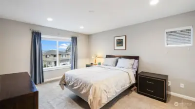 This bedroom features a window with a view of the outside.