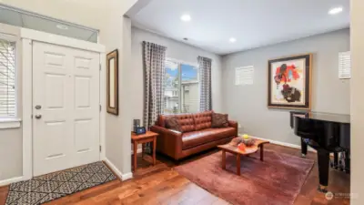 A grand piano and couch welcomes you as you enter the home.