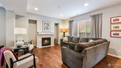 This view highlights the fireplace at the center of the living room.