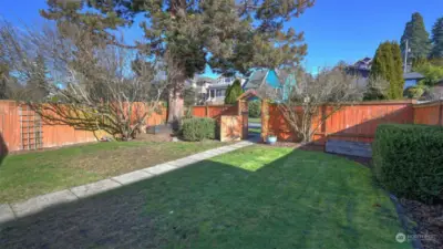 Fully fenced spacious front yard.