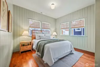 Main-level bedroom features shiplap, and large closet with built-ins