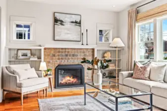 South-Facing Living Room features original Batchedler tile with updated gas fireplace.