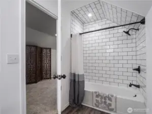 Full bathroom was recently remodeled and features luxury laminate flooring, subway tile, soaker tub, and vanity with a stone countertop.