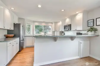 The large picture window over the sink floods the space with natural light and offers a serene view of the backyard.