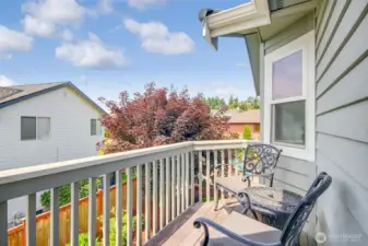 Private deck off of primary suite with water and mountain view.