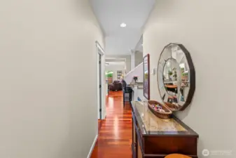 Main level hallway leading to 2nd guest bedroom, laundry, full bathroom and garage.