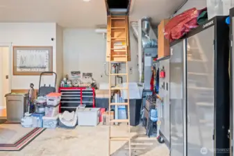 The two-car garage contains the furnace with AC and tankless water heater. There is access to the attic via the pull-down staircase and there is plenty of storage.