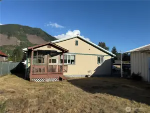 Back of home with a porch