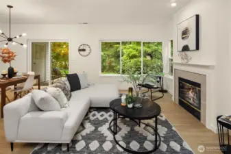 Large living room area, with focal gas fireplace for cozy nights in. Large picture windows offer views to the HOA maintained greenspace