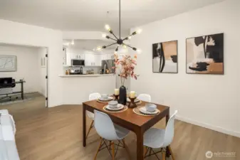 Dining area with updated modern light fixtures.