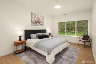 Large primary suite overlooking the greenspace, offering maximum privacy. Plenty of room for lounge chairs or additional dressers as needed