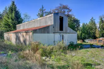 4 stall barn with feed and tack rooms. Water and power present as well.