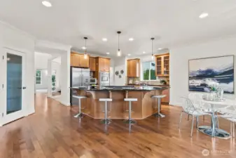 Kitchen has large island with room for 4 and a walk-in pantry to the left.