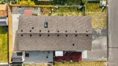 Simple yard maintenance for the busy home owner. Just a little grass in top right and upper side of photo. The rest is full of pavers, bark, and repurposed rock by the driveway.