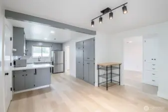 Photo is from dining room toward kitchen to the left & living room to the right. Tons of cabinetry/storage in kitchen area.