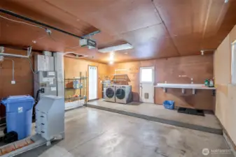 Oversized 2 car garage with step up to washer & dryer (both convey w/ sale).  Passage door from garage to back patio/yard for easy access :-)