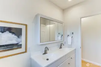 The full hall bath has double vanities and tiled tub/shower.