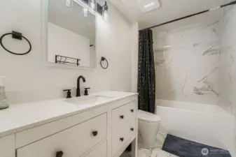 Full bath with tub/shower combo.