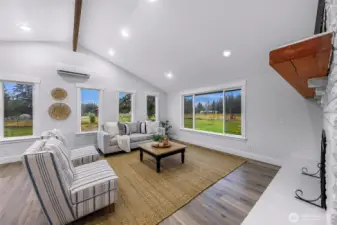 Large and open concept living space, plenty of bright natural light and vaulted ceilings and wood accent beams