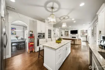 The heart of any home-the kitchen! Slab granite countertops and custom cabinetry, richly hued LVP flooring.