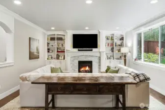 Inviting living room with stone accented gas fireplace.