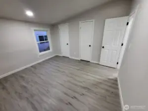 Bedroom #2; We just entered through the doorway on the far right wall. The two closed doors are a linked, ultra spacious closet w/ clothing bar from end to end w/ storage shelf on top (can be walked through!)