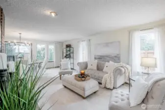 Spacious living/dining room with cozy fireplace.