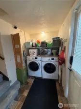 Laundry area, built in iron board and door leading to back yard
