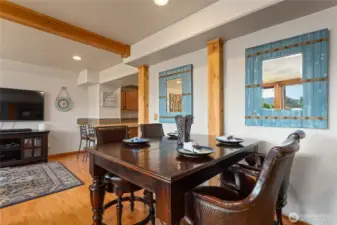 View 2 of lower level living/media room w/ fireplace, dining area and 2nd kitchen w/ doors leading out to the patio w/ pool, hot tub, basketball court and dining and lounge area.