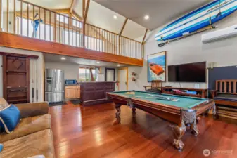 Detached carriage house w/ game area, kitchenette, bathroom and upper balcony exercise area.