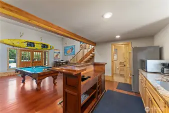 Detached carriage house w/ game area, kitchenette, bathroom plus upper balcony exercise area.