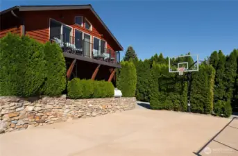 View of detached carriage house w/ view deck and private basketball court.