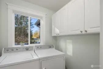 Laundry room with built-in cabinetry for extra storage.