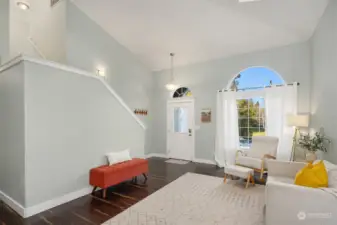 Formal living room with vaulted ceilings and skylights lets in an abundance of light.