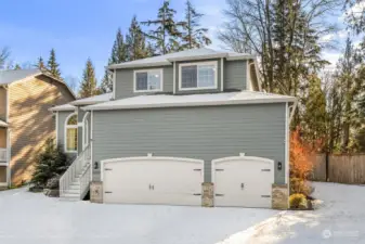 A generous 3-car garage with an upper loft provides ample storage.