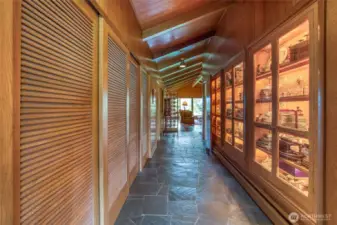 The hallway leading to the Primary suite has ample storage room in the closet and a lighted display cabinet to display fine collectables.