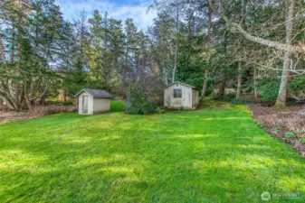The well pump house, a garden shed, and the storage tank.