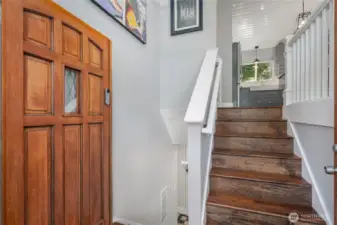 Foyer leads to wood floors & open staircase