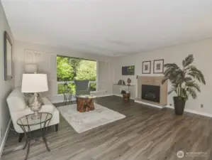 Nice living room with new floors and new cozy gas fireplace.