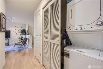 Hallway to primary bedrooom, more storage and w/d