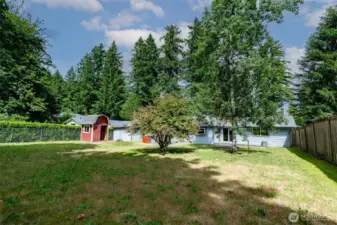 View of fenced back yard from SW corner