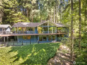 A true retreat—nestled among the trees and thoughtfully designed for elevated, effortless living. Walls of windows and seamless outdoor access connect every space to the surrounding beauty.