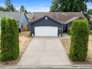 Tidy landscaping and a long driveway lead to this charming home tucked away on a peaceful loop street.
