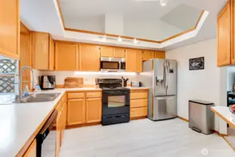 Vaulted ceilings and skylights bring natural light into this open kitchen with generous counter space.
