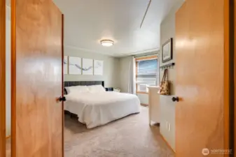 French doors open to the spacious Primary Suite with ample room for a king-size bed and cozy sitting area.