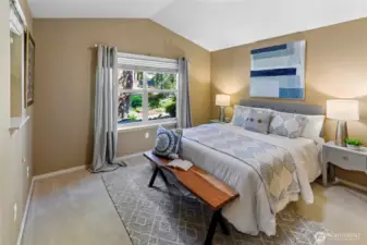 Main floor primary bedroom with vaulted ceiling
