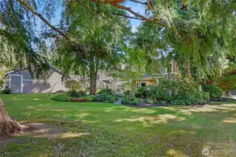 Nice lawn area in front of condominium. Person door to garage is on left
