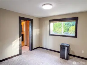 This is the Primary Bedroom with a/c unit and tv mounted