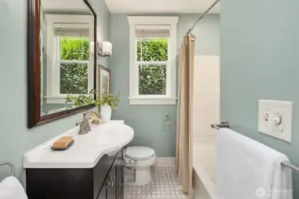 Remodeled bathroom with tile floor.